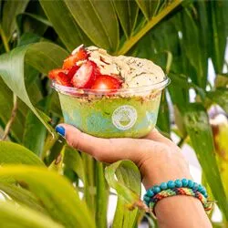 playa bowls green smoothy being held up
