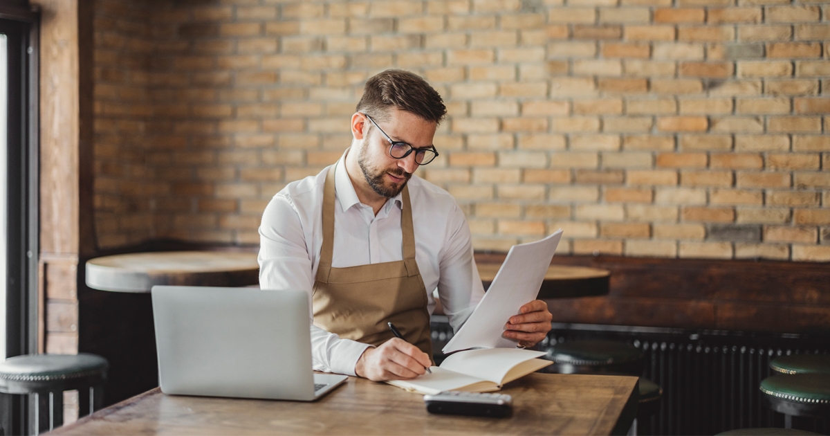 restaurant worker doing finances with computer