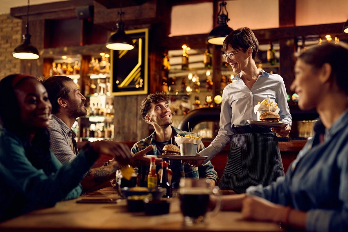 waitress delivering food at pub