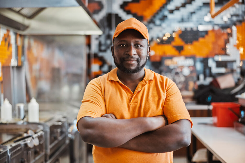 Business Owner in front of kitchen