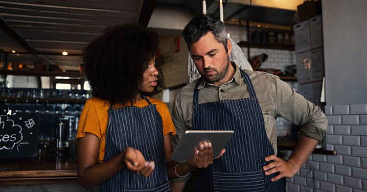 Photo of restaurant owners talking about what to do with past due sales tax