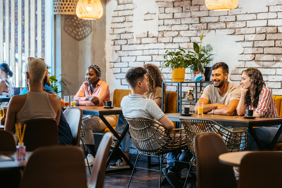 mesas de restaurante con gente comiendo
