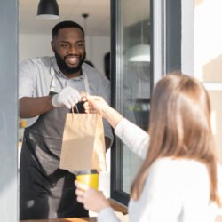 man handing bag to woman