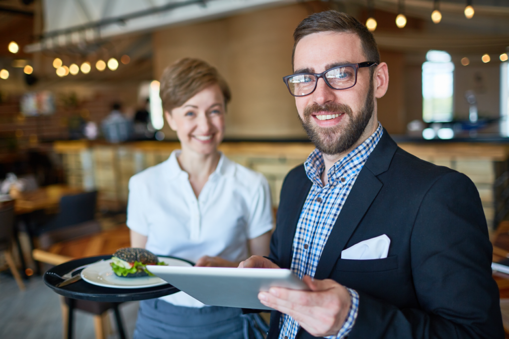Restauranteurs smiling at camera