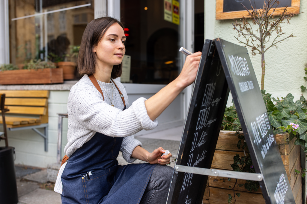 Restaurant owner changing menu outside of business