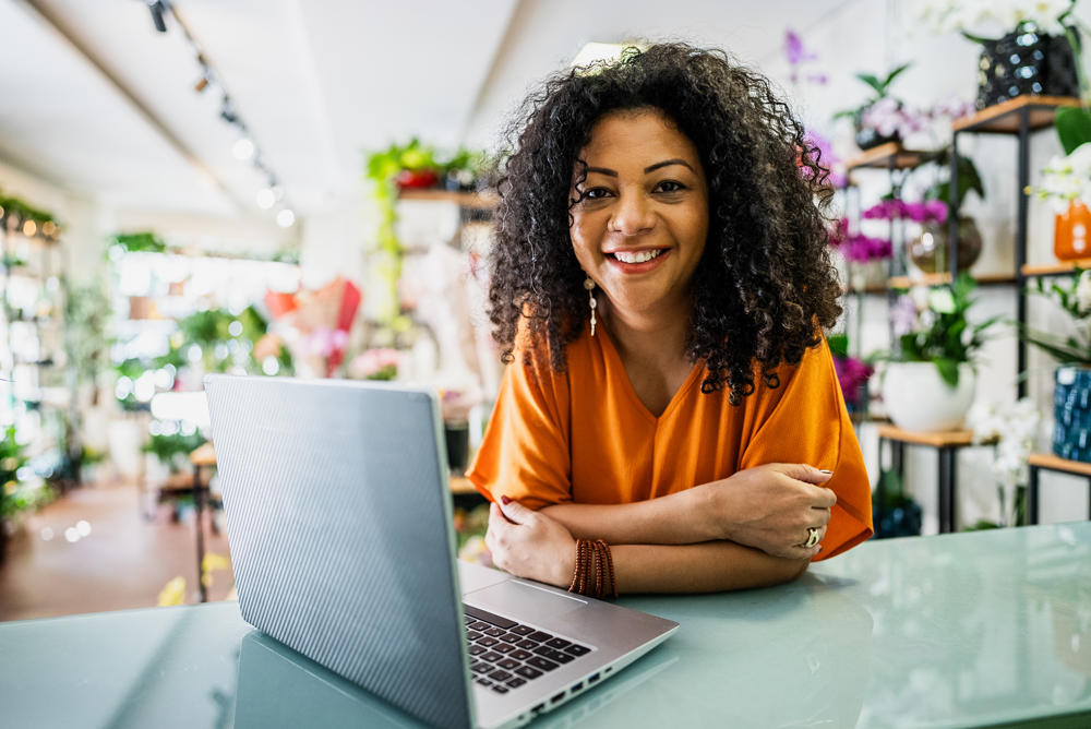 Small Business owner leaning on counter